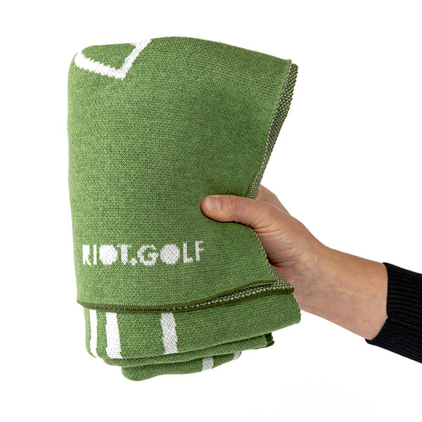 knitted Golf Blanket in green and white with golf geek design and riot golf logo